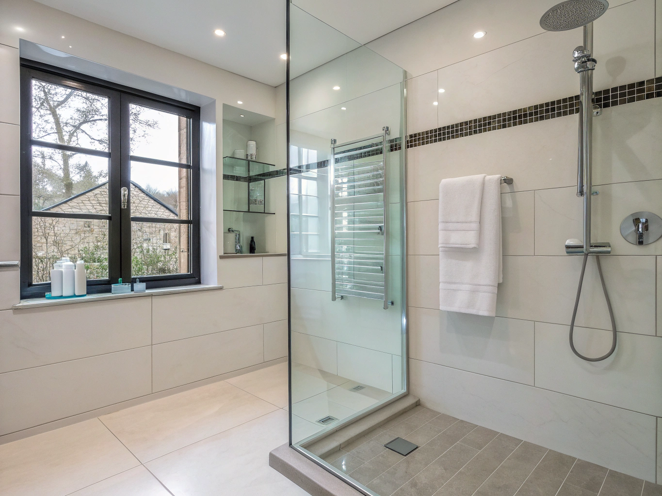 Contemporary walk-in wet room with large format slate tiles and brushed brass brassware